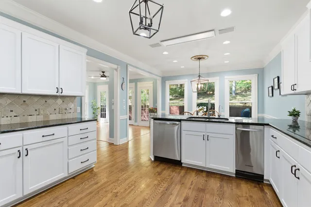 a kitchen with counter top space sink and cabinets