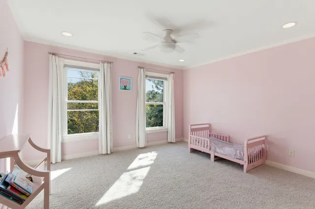 an empty room with wooden floor and a ceiling fan