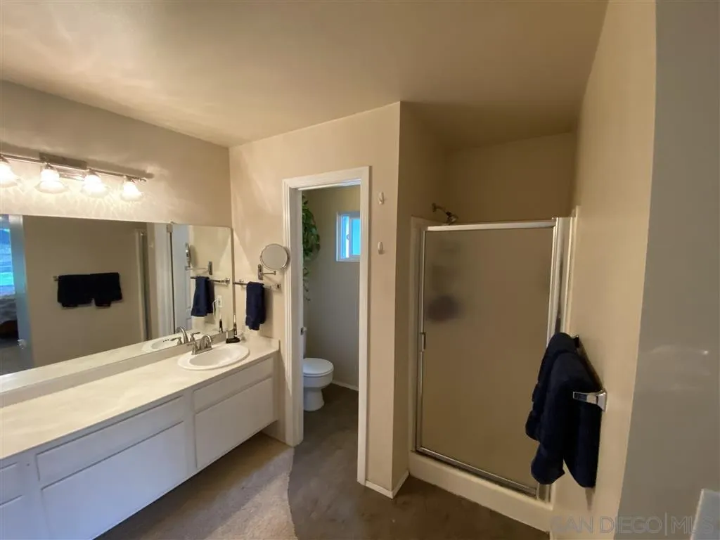 911 La Buena Vida Fallbrook, CA 92028 - Photo 15 of 24 a bathroom with a double vanity sink and mirror
