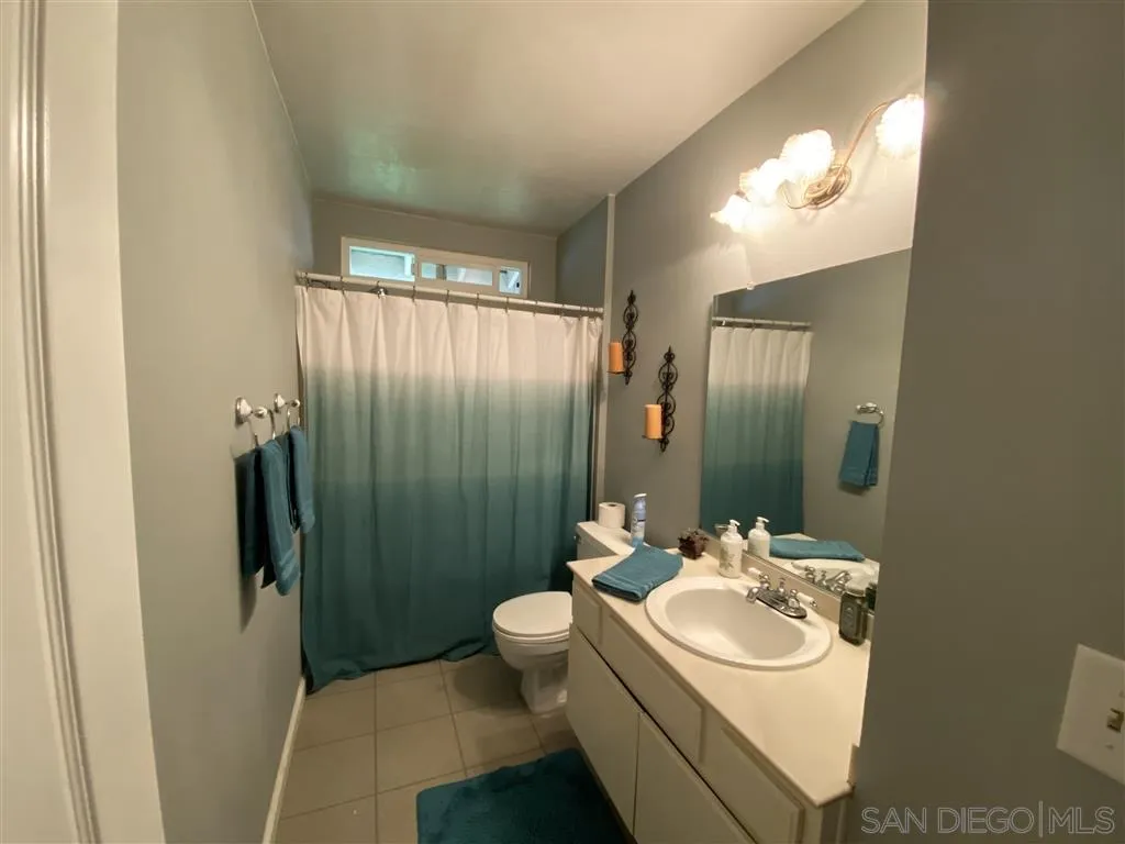 911 La Buena Vida Fallbrook, CA 92028 - Photo 17 of 24 a bathroom with a sink toilet and shower