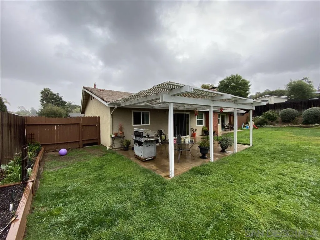 911 La Buena Vida Fallbrook, CA 92028 - Photo 20 of 24 a view of a house with a yard and sitting area