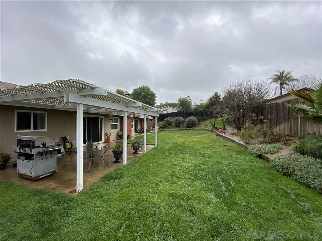 911 La Buena Vida Fallbrook, CA 92028 - Photo 21 of 24 a view of a house with backyard sitting area and garden