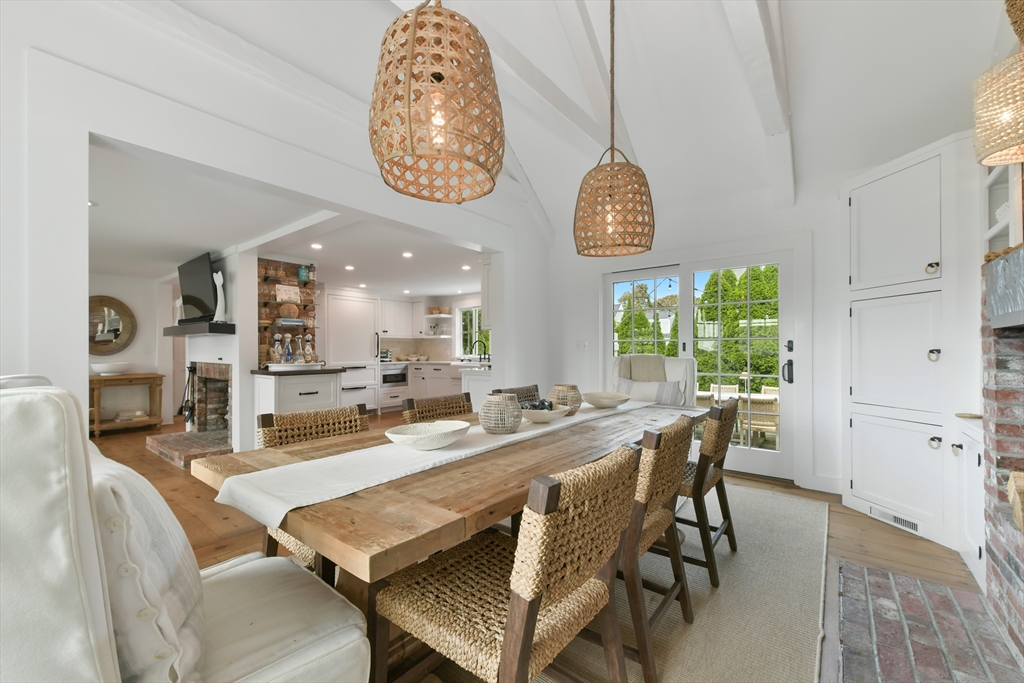 8 Port Pines Road Harwich Port, MA 02646 - Photo 12 of 42 a dining room with wooden floor a chandelier a wooden table and chairs