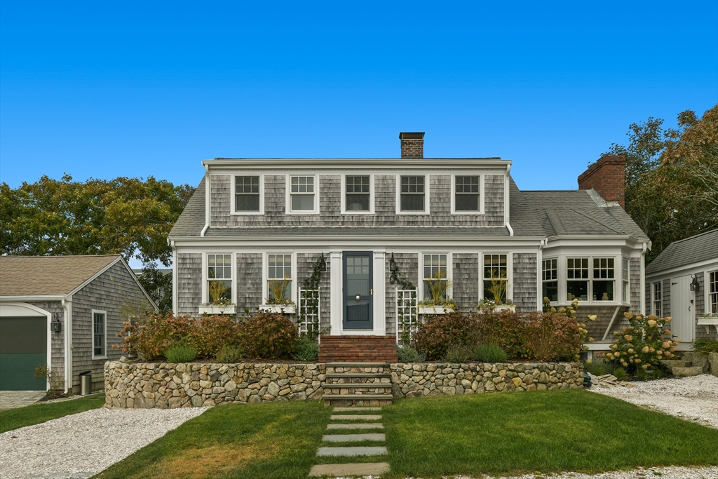 8 Port Pines Road Harwich Port, MA 02646 - Photo 5 of 42 a front view of a house with a yard