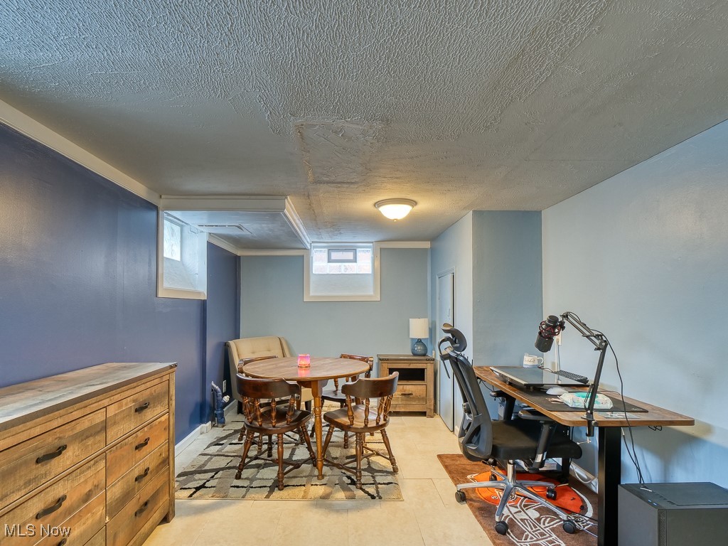 6794 York Road Cleveland, OH 44130 - Photo 39 of 45 basement Dining area featuring a textured ceiling and an office area