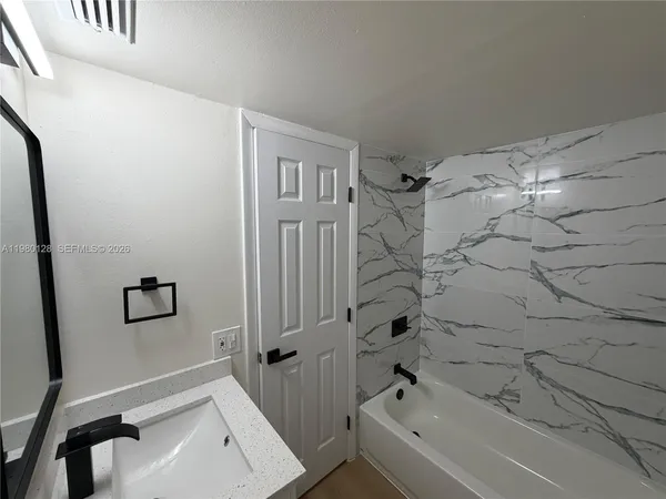 a bathroom with a bathtub and shower