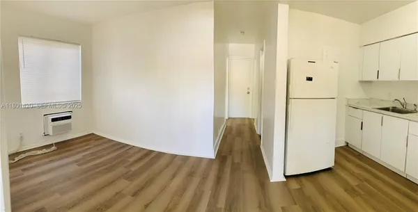 a view of kitchen with wooden floor
