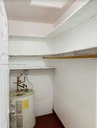 a utility room with a stove and a white cabinet