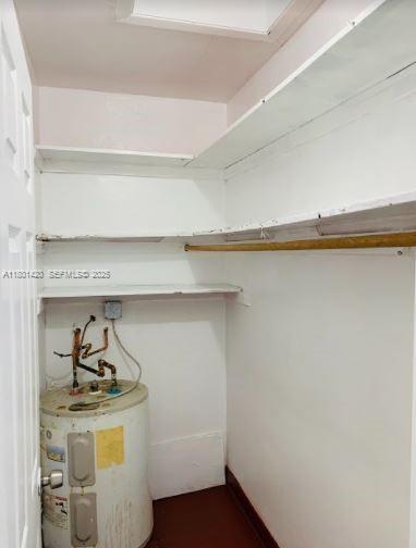 691 Northeast 86th Street, Unit 3 Miami, FL 33138 - Photo 8 of 10 a utility room with a stove and a white cabinet