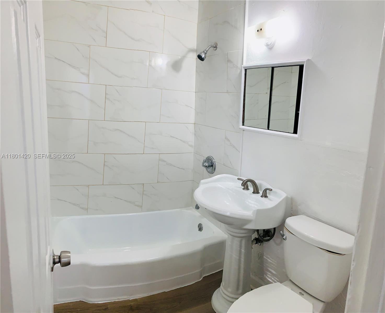 691 Northeast 86th Street, Unit 3 Miami, FL 33138 - Photo 9 of 10 a bathroom with a sink toilet and shower