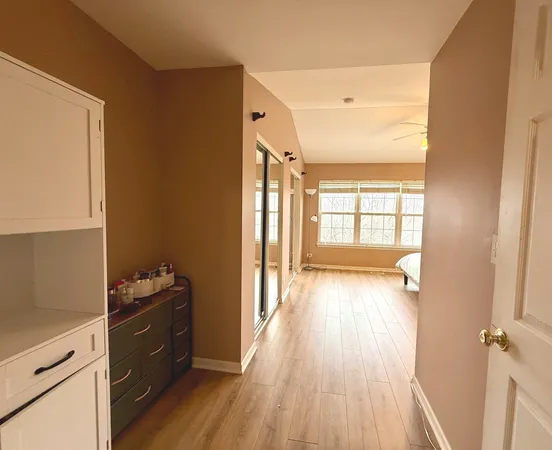 a view of wooden floor and windows in a room