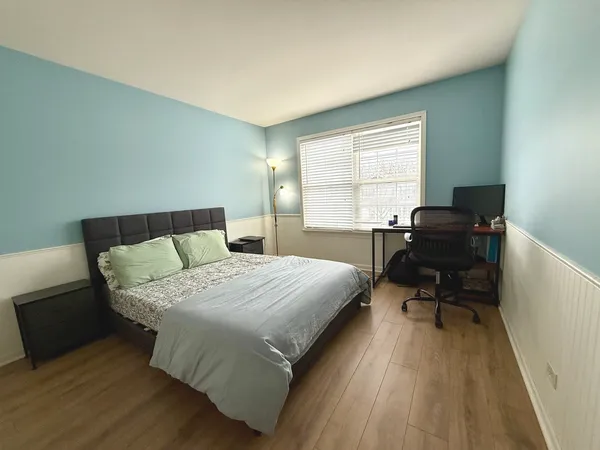 a bedroom with a bed and a desk