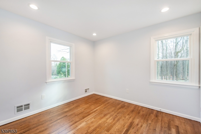 267 Washington Valley Road Randolph, NJ 07869 - Photo 12 of 42 an empty room with wooden floor and windows