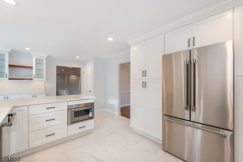 267 Washington Valley Road Randolph, NJ 07869 - Photo 18 of 42 a kitchen with white cabinets and stainless steel appliances