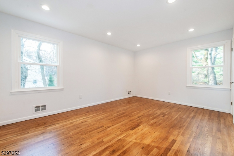 267 Washington Valley Road Randolph, NJ 07869 - Photo 30 of 42 an empty room with wooden floor and windows
