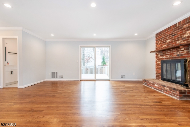 267 Washington Valley Road Randolph, NJ 07869 - Photo 7 of 42 a view of an empty room with window and wooden floor
