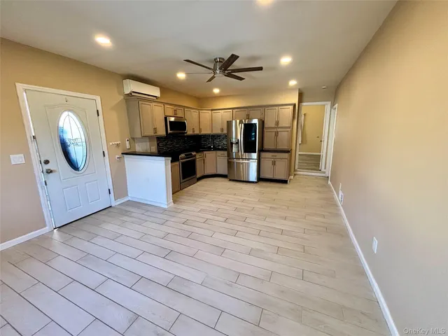 a view of kitchen with microwave and cabinets