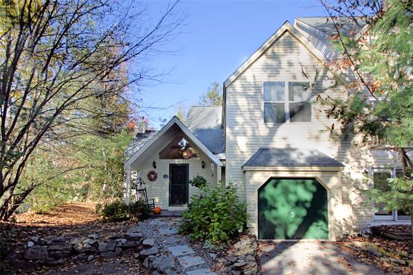 14 Deer Path, Unit 14 Hudson, MA 01749 - Photo 1 of 18 a front view of a house with garden