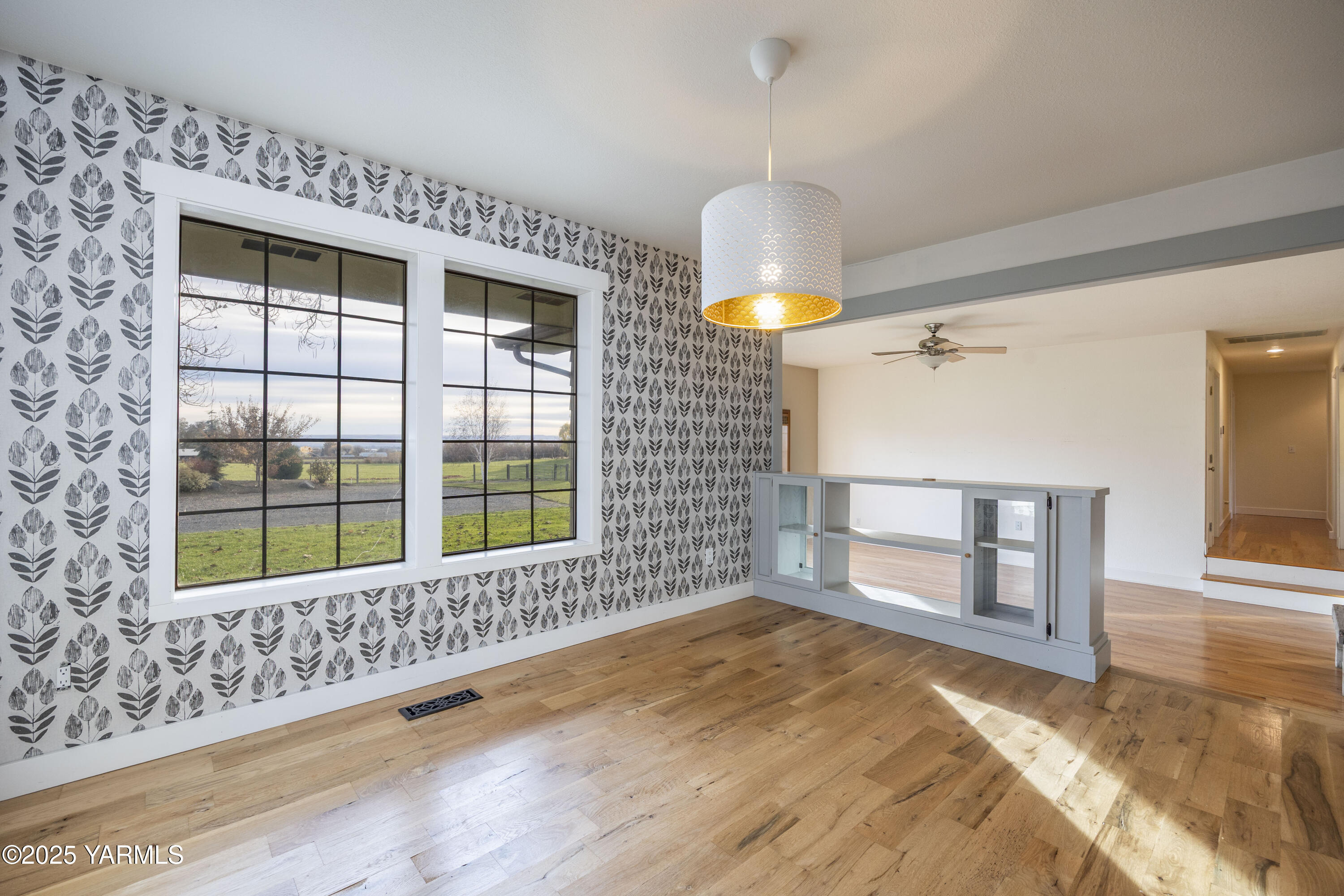 10240 Van Belle Road Sunnyside, WA 98944 - Photo 11 of 52 a view of empty room with window and chandelier