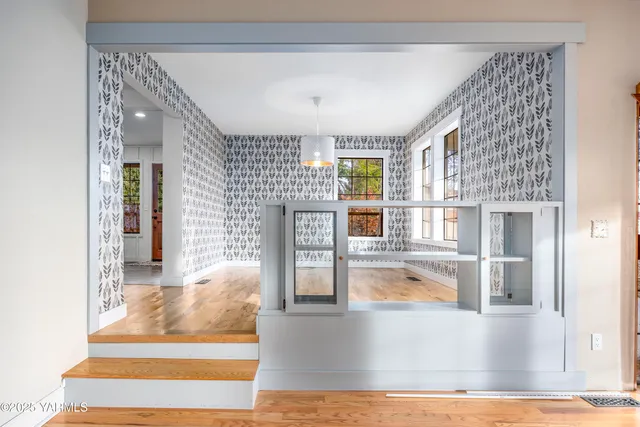 a view of a livingroom with wooden floor and a fireplace