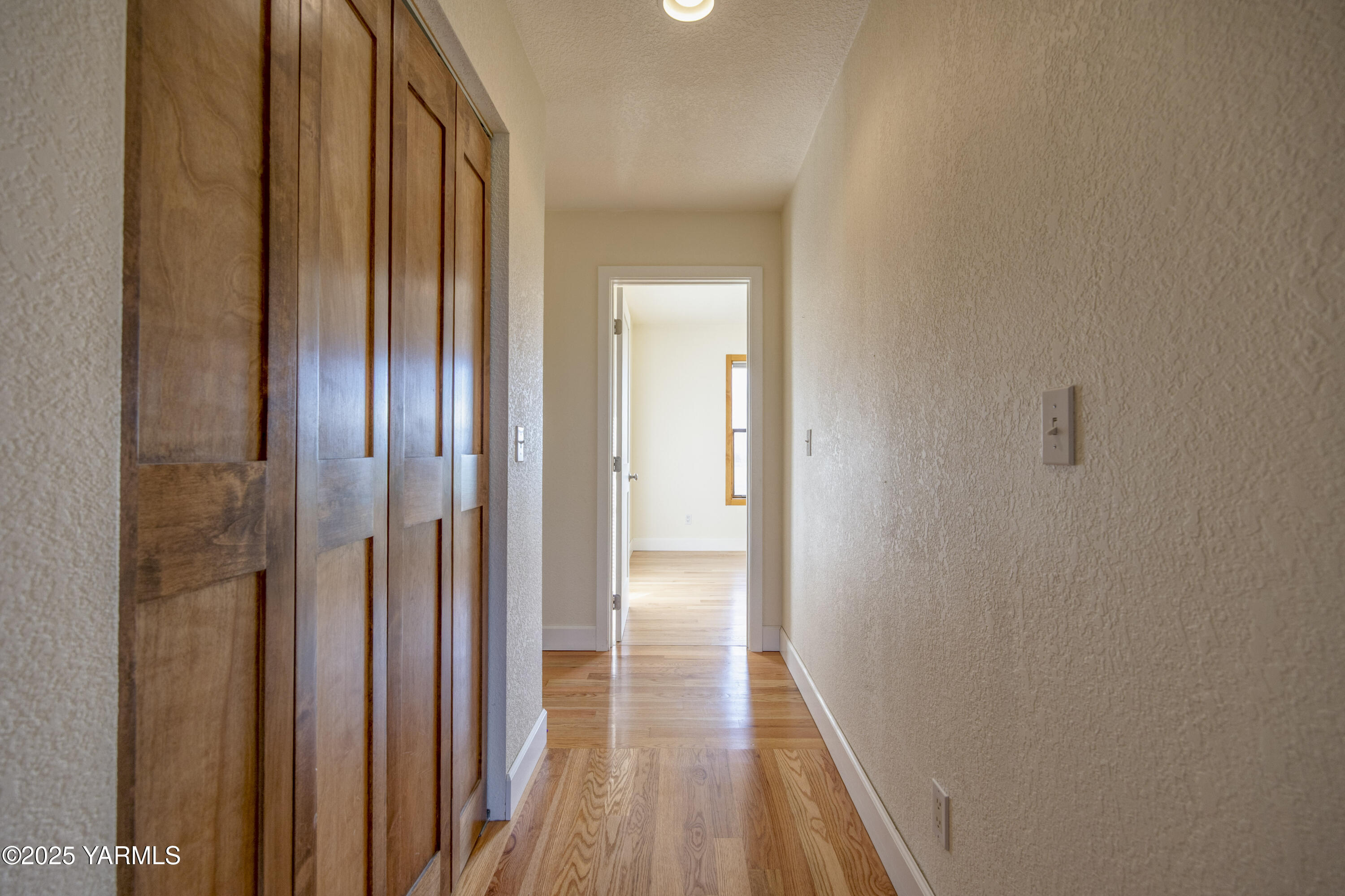 10240 Van Belle Road Sunnyside, WA 98944 - Photo 26 of 52 a view of a hallway with wooden floor