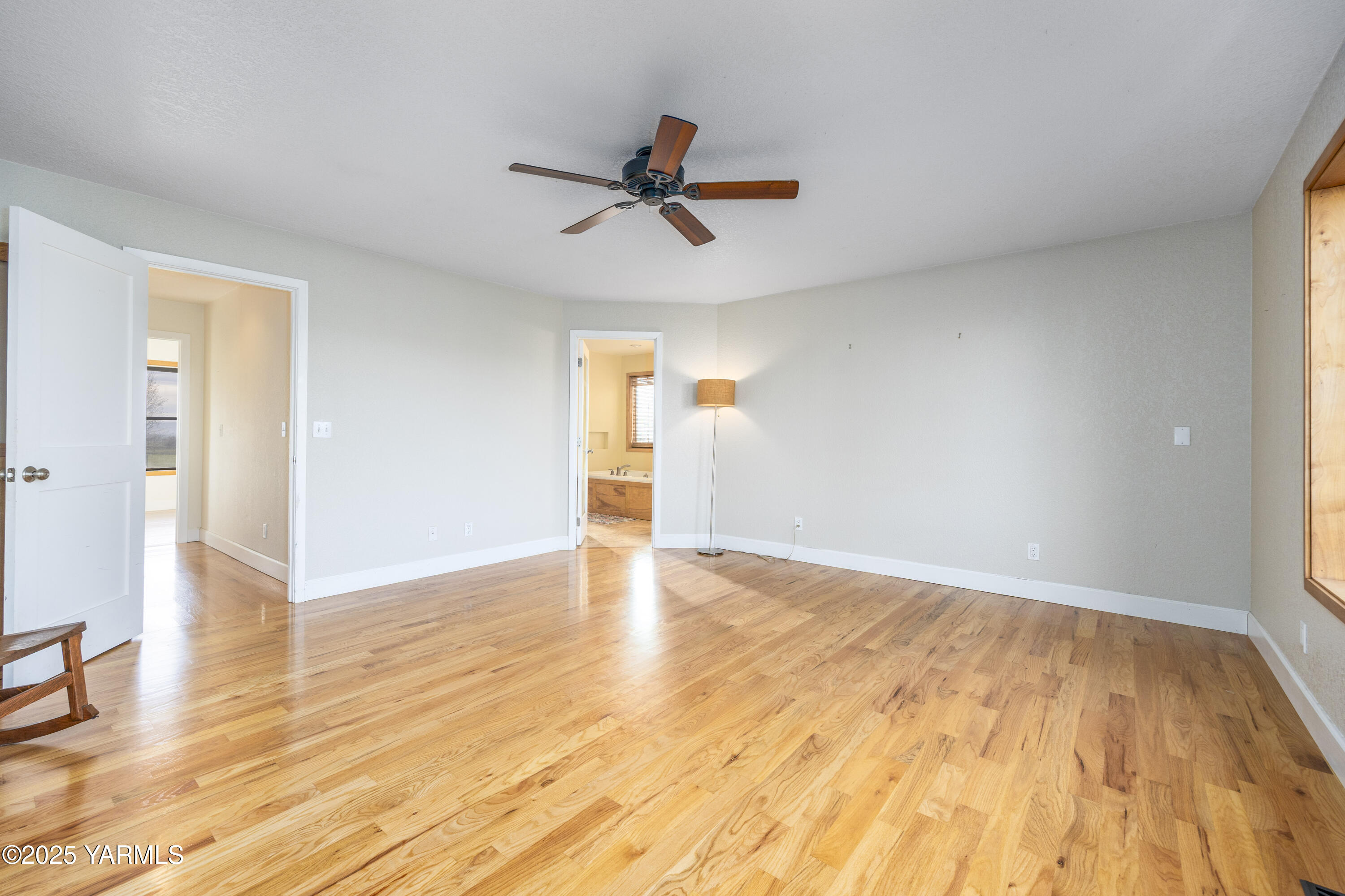10240 Van Belle Road Sunnyside, WA 98944 - Photo 32 of 52 a view of empty room with wooden floor and fan