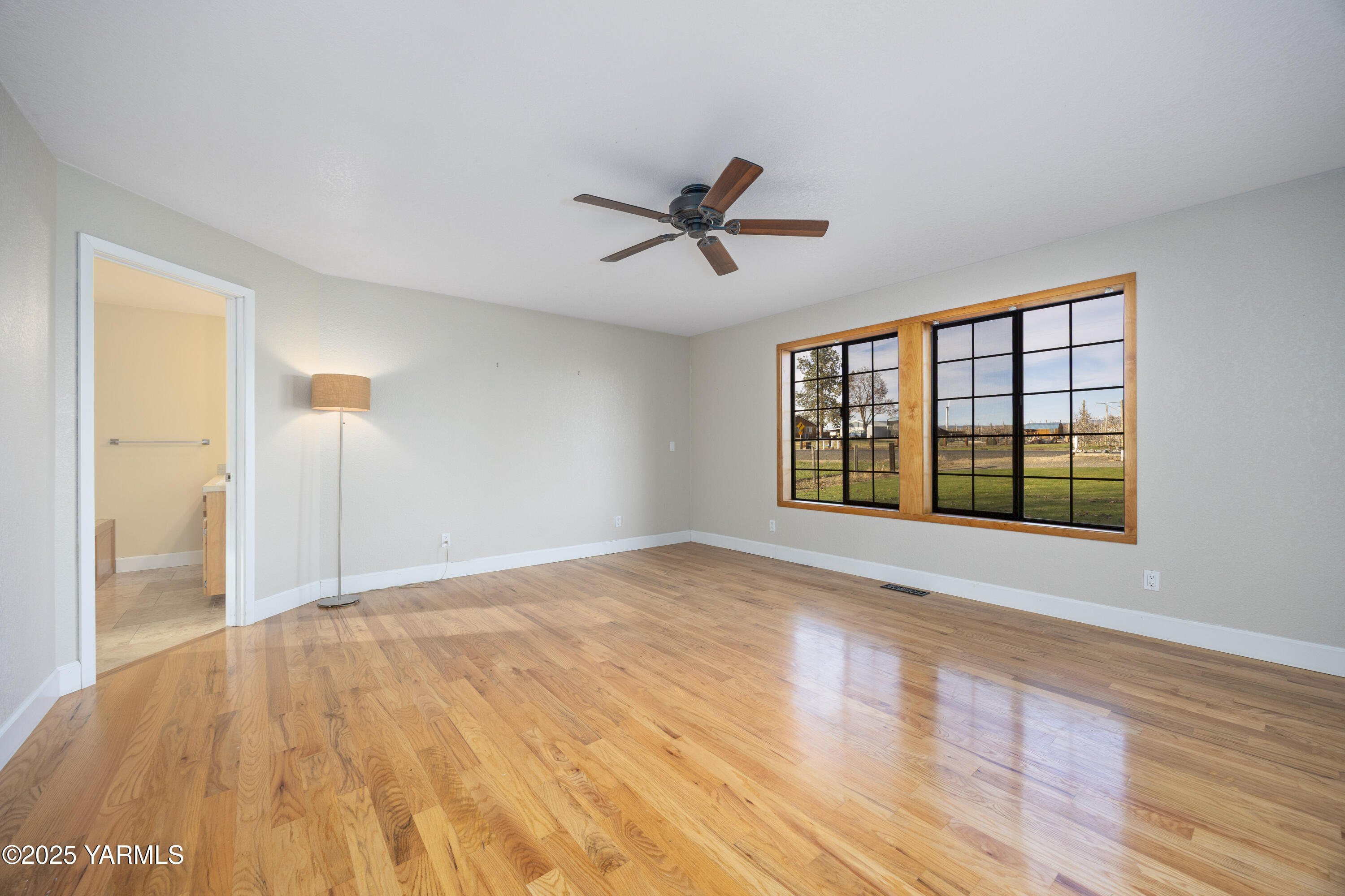 10240 Van Belle Road Sunnyside, WA 98944 - Photo 33 of 52 a view of empty room with wooden floor and fan