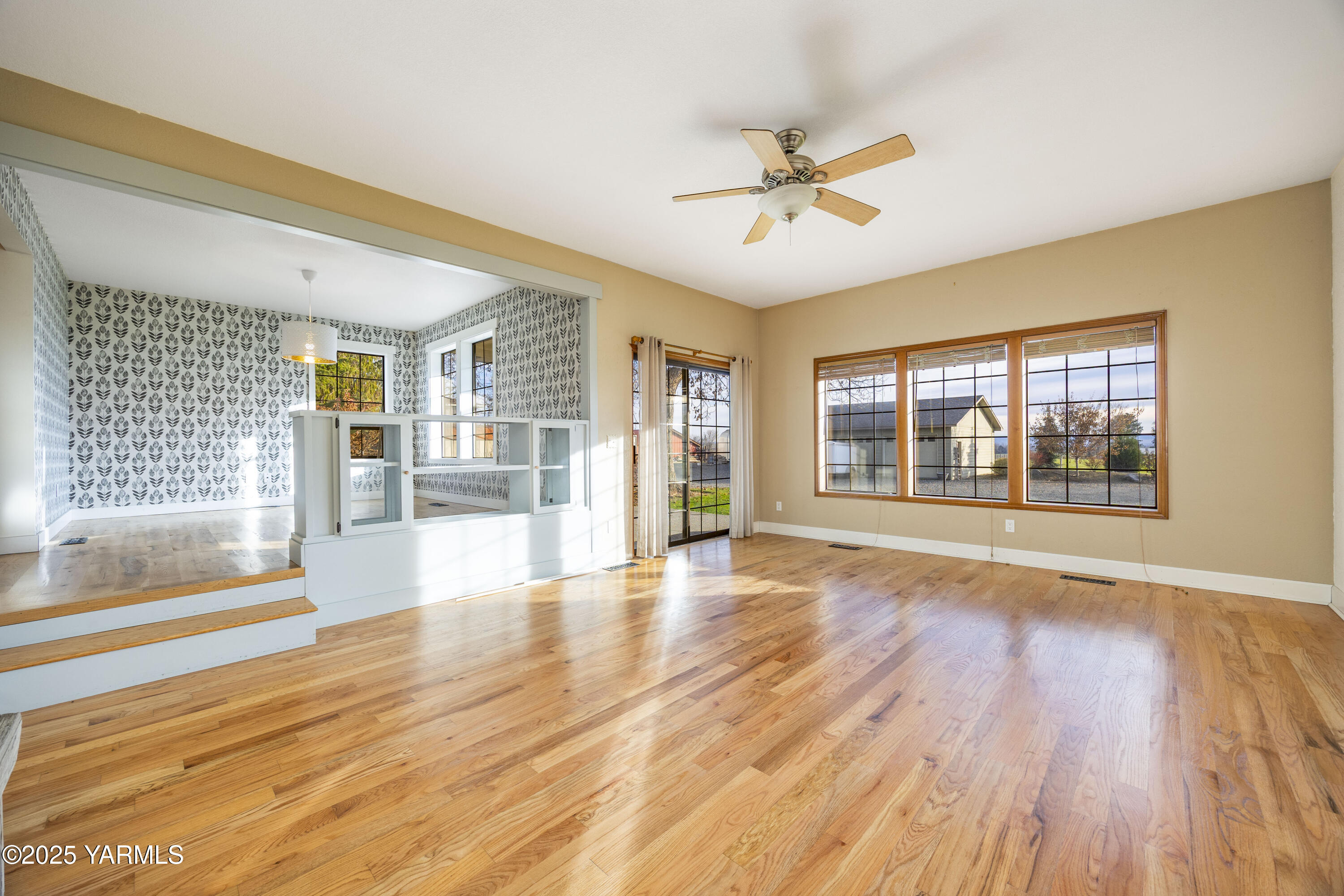 10240 Van Belle Road Sunnyside, WA 98944 - Photo 6 of 52 a view of an empty room with wooden floor and a window