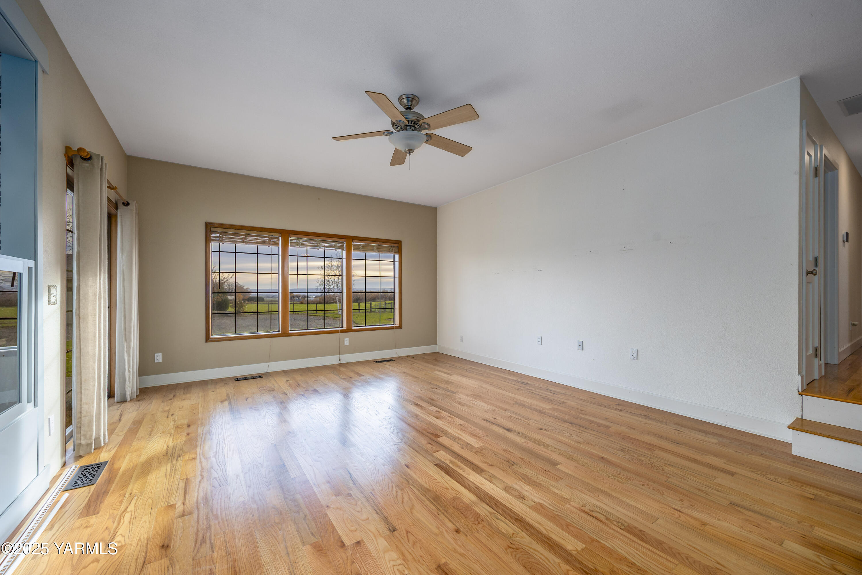 10240 Van Belle Road Sunnyside, WA 98944 - Photo 9 of 52 wooden floor in an empty room with a window