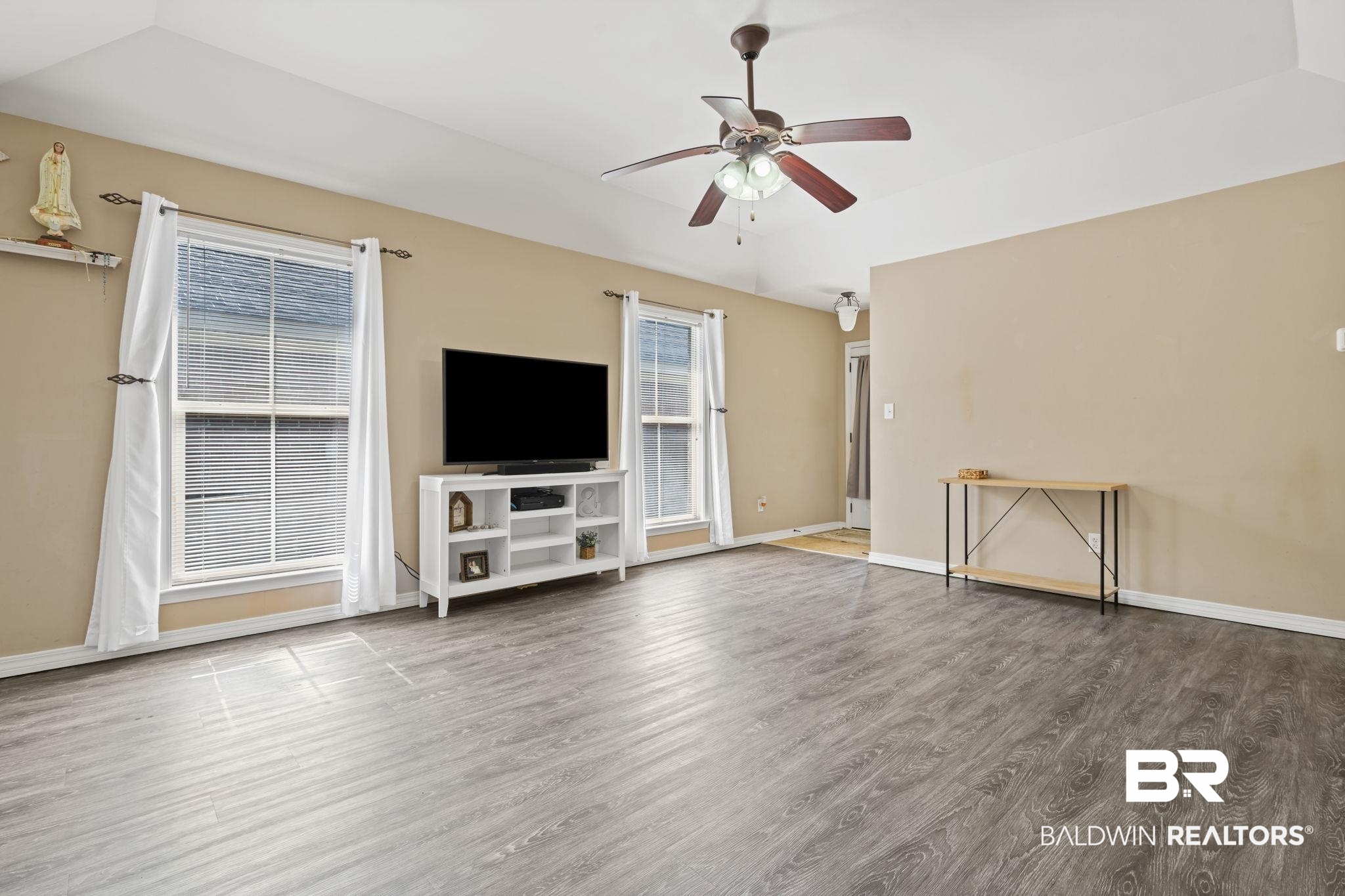 8956 Spring Grove North Mobile, AL 36695 - Photo 3 of 19 Unfurnished living room featuring wood finished floors, a ceiling fan, lofted ceiling, and baseboards
