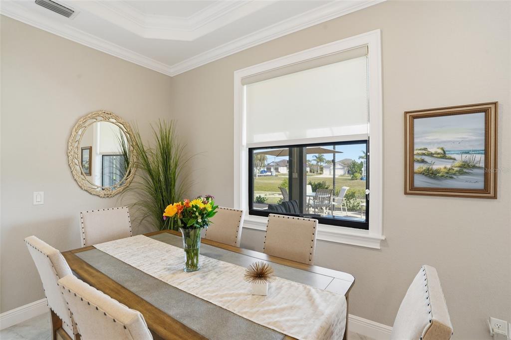 7416 South Seagrape Road Punta Gorda, FL 33955 - Photo 12 of 39 a dining room with furniture and wooden floor