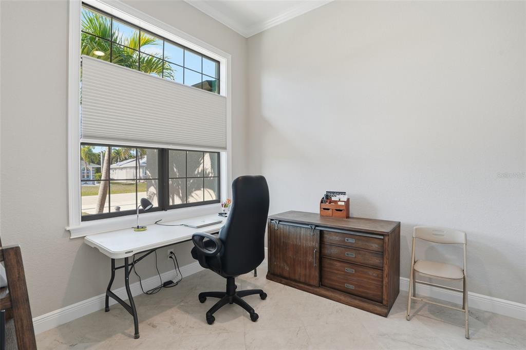 7416 South Seagrape Road Punta Gorda, FL 33955 - Photo 13 of 39 a view of a workspace with furniture and a window