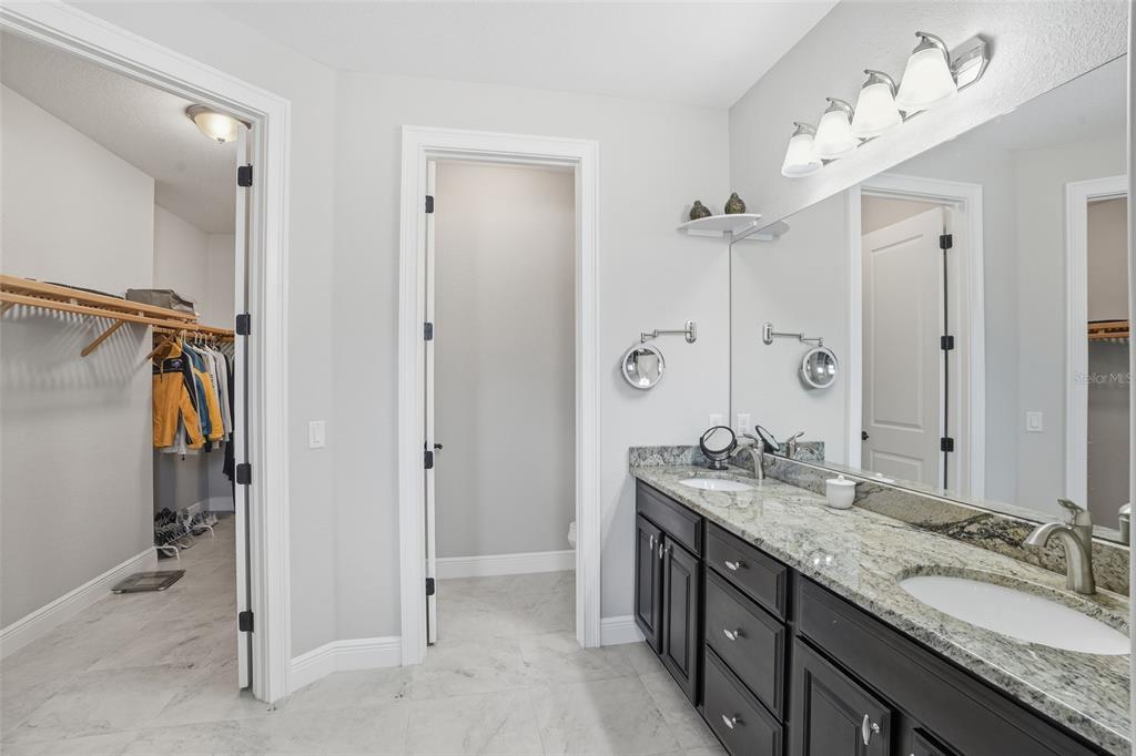 7416 South Seagrape Road Punta Gorda, FL 33955 - Photo 19 of 39 a bathroom with a granite countertop double vanity sink mirror and shower