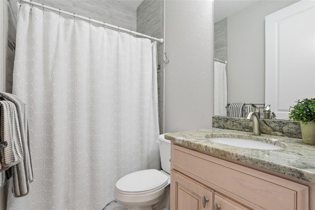 7416 South Seagrape Road Punta Gorda, FL 33955 - Photo 23 of 39 a bathroom with a granite countertop sink and a mirror