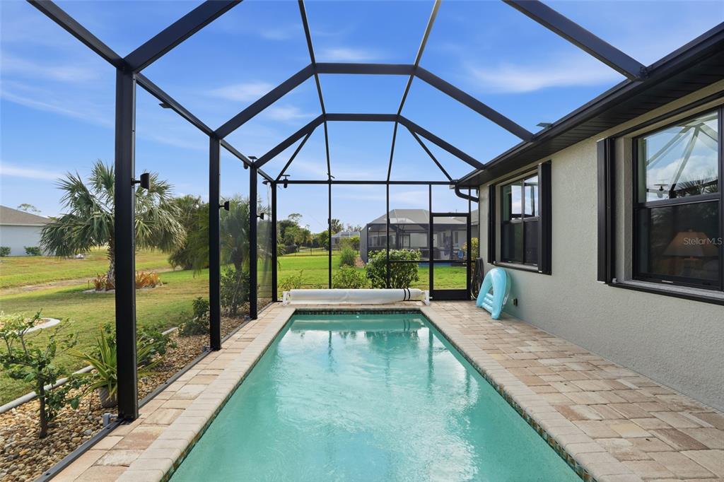 7416 South Seagrape Road Punta Gorda, FL 33955 - Photo 32 of 39 a porch with a table and chairs