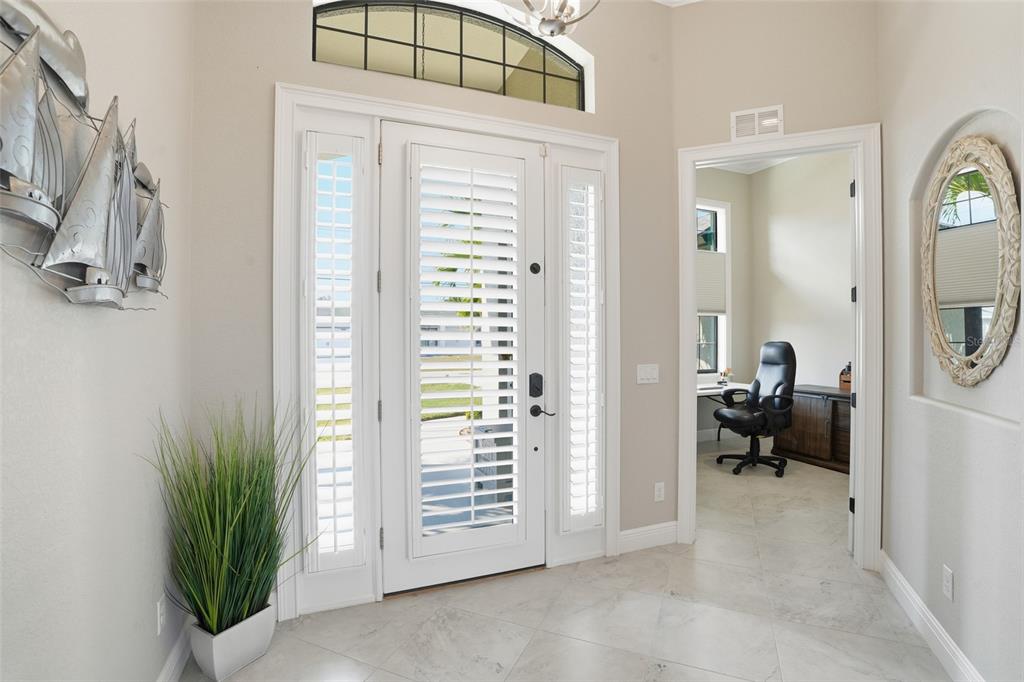 7416 South Seagrape Road Punta Gorda, FL 33955 - Photo 5 of 39 a view of a hallway with living room and a yard