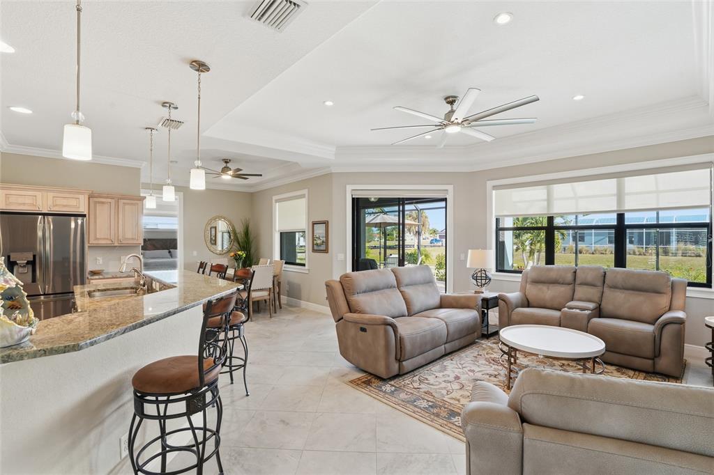 7416 South Seagrape Road Punta Gorda, FL 33955 - Photo 6 of 39 a living room with furniture a ceiling fan and a window