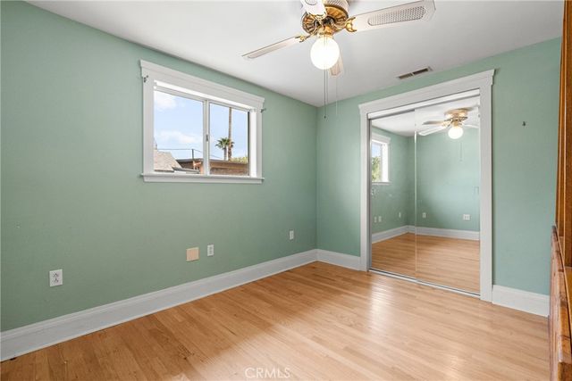 an empty room with fan and windows