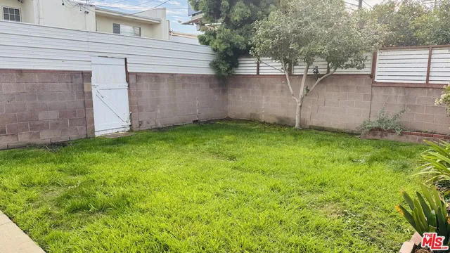 a front view of house with a garden