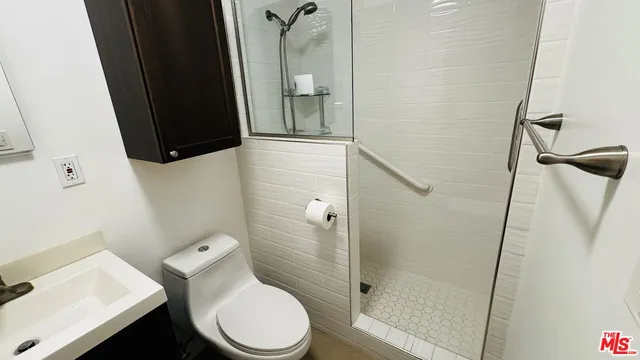 a bathroom with a toilet and a shower