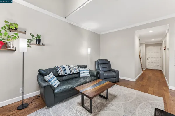 a living room with furniture and flowers