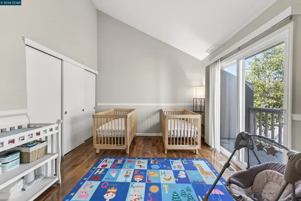 a bedroom with furniture and a rug