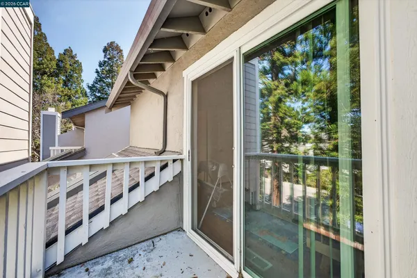 a view of balcony with wooden floor and fence