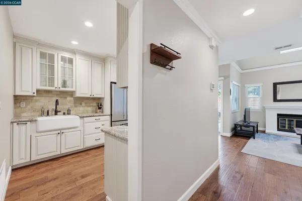a kitchen with white cabinets and appliances