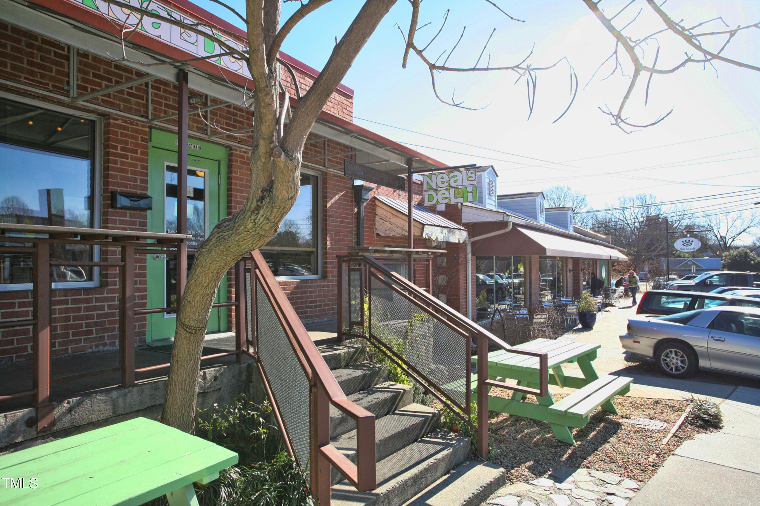 140 Two Hills Drive, Unit 201C Carrboro, NC 27510 - Photo 12 of 16 a view of a balcony with two chairs and a barbeque