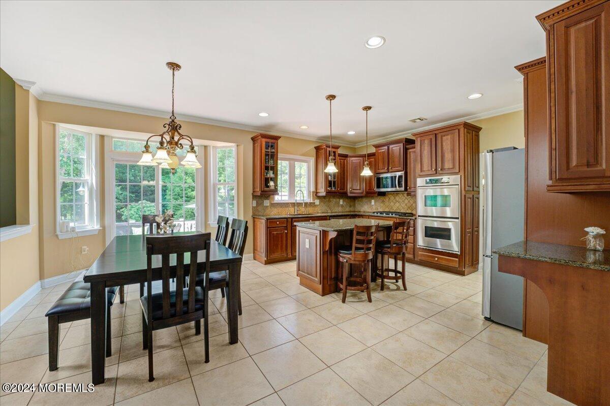 26 Emily Road Manalapan, NJ 07726 - Photo 11 of 49 a view of a dining room with furniture window and outside view