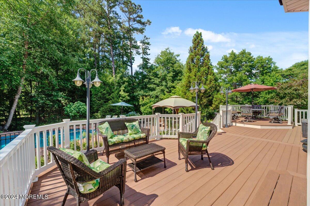 26 Emily Road Manalapan, NJ 07726 - Photo 36 of 49 a view of a balcony with wooden floor and outdoor seating