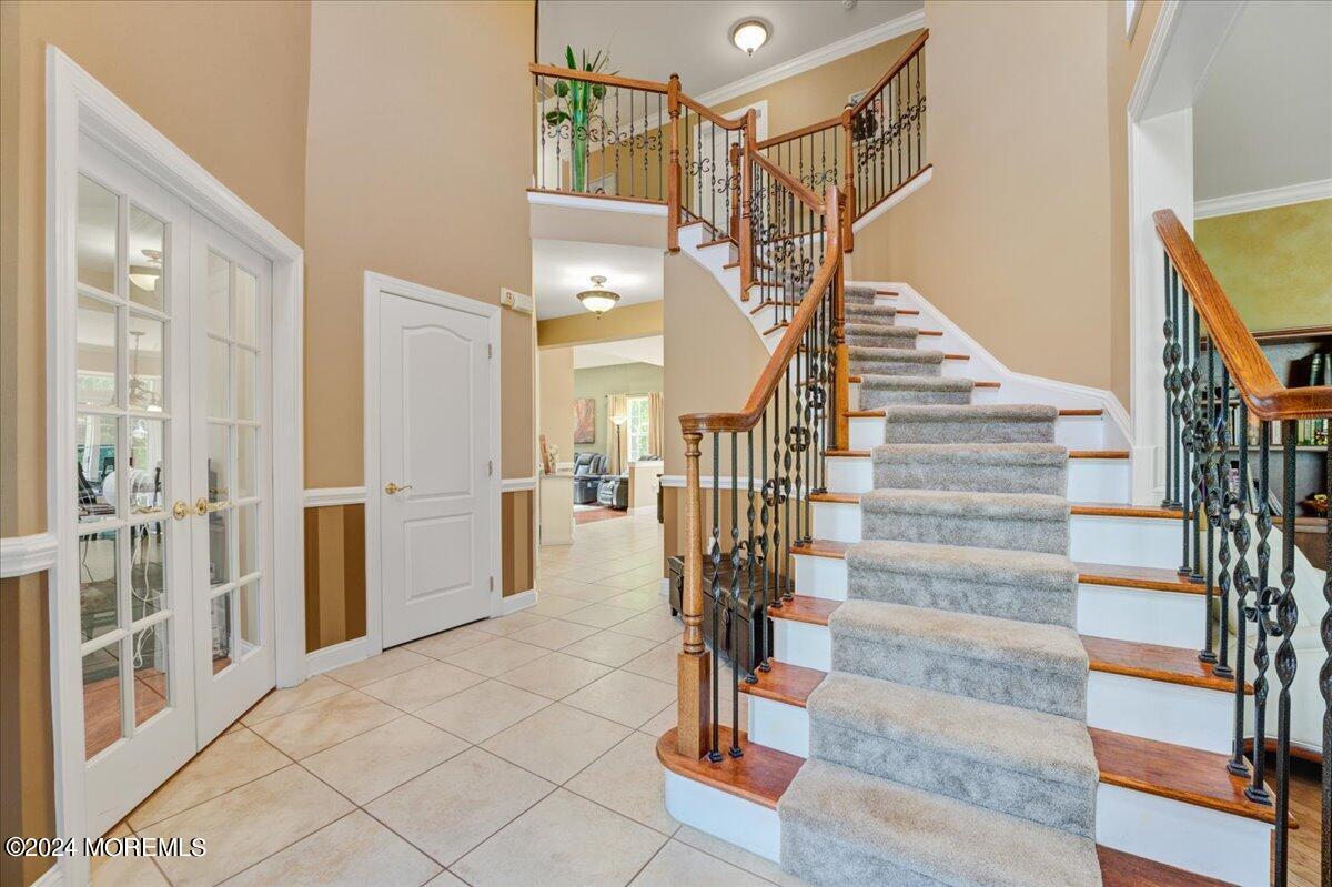 26 Emily Road Manalapan, NJ 07726 - Photo 4 of 49 a view of entryway and hall with wooden floor