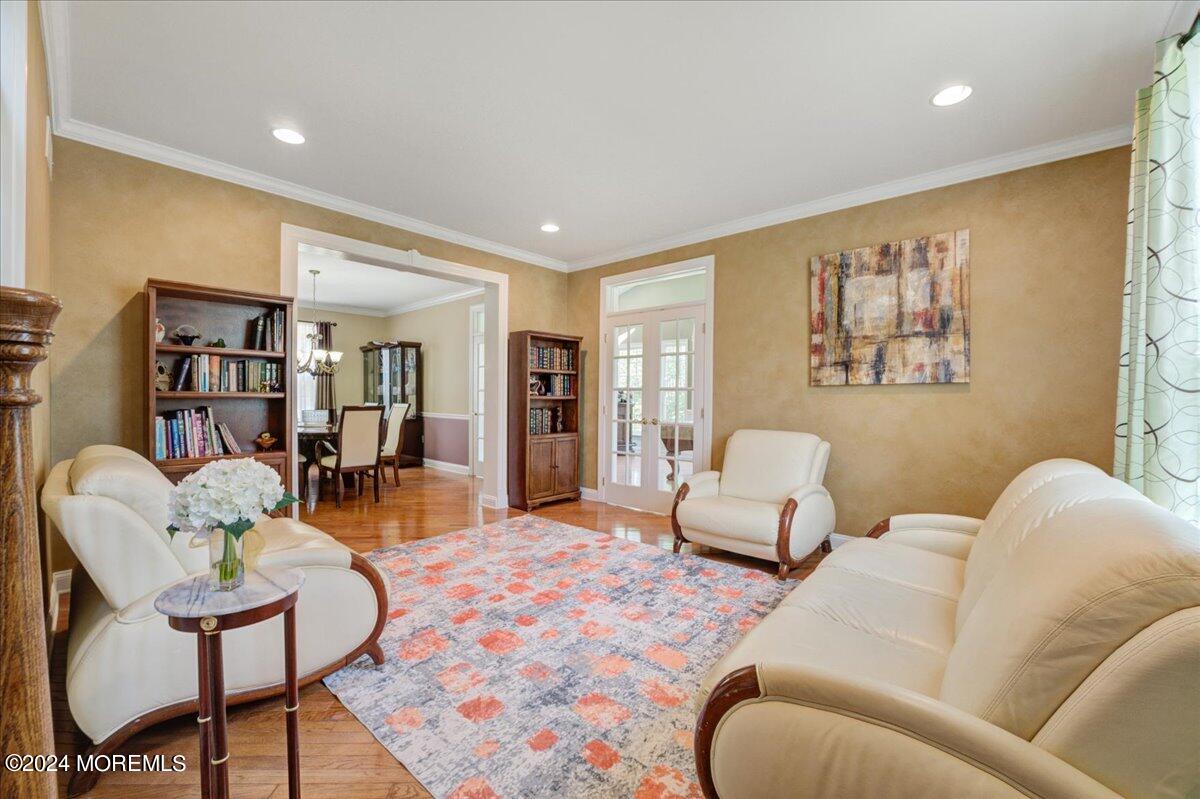 26 Emily Road Manalapan, NJ 07726 - Photo 7 of 49 a living room with furniture and a book shelf
