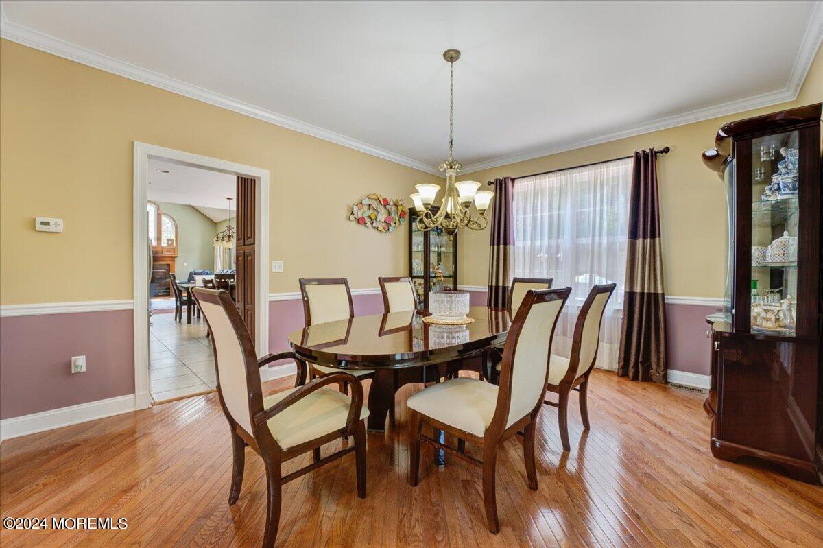 26 Emily Road Manalapan, NJ 07726 - Photo 8 of 49 a view of a dining room with furniture window and wooden floor
